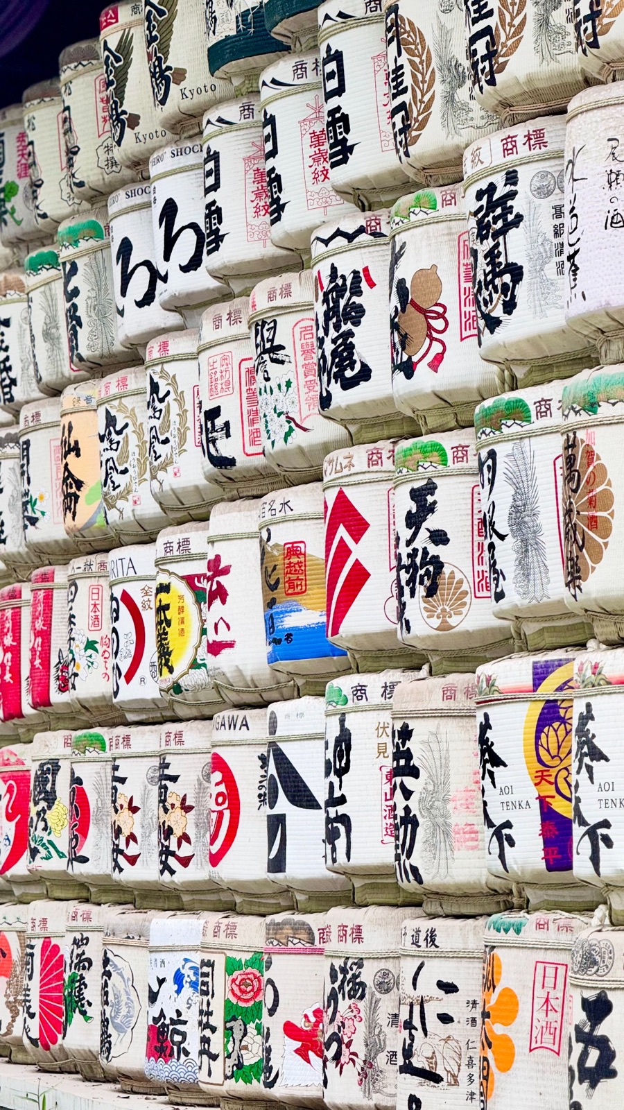Rows of decorated sake barrels