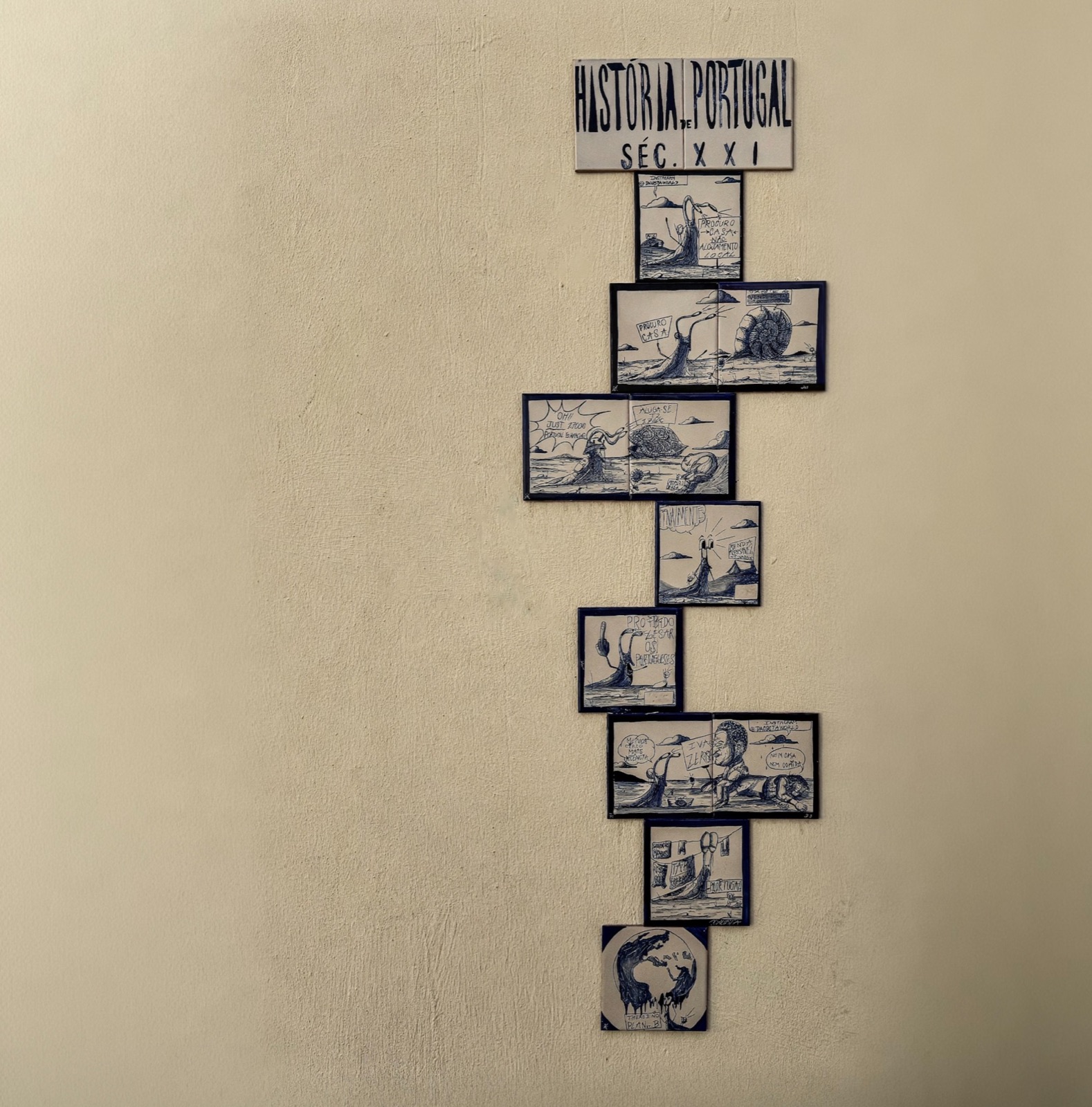 Historic illustrated Portuguese tiles arranged on a pale wall